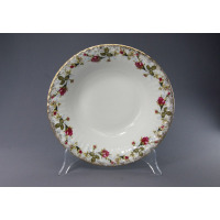 Okrągła salaterka Chodzież Iwona B013 o średnicy 26 cm z białej porcelany, zdobiona motywem róż i złotym wykończeniem brzegów, wyeksponowana na przezroczystym