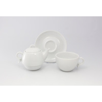 Biały zestaw do herbaty Lubiana Bola 2 składający się z czajnika, filiżanki i spodka. Minimalistyczna porcelana o gładkiej fakturze na jasnym tle.