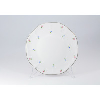 Talerz płytki 26 cm 0112 JASTRA marki Lubiana na przezroczystym stojaku. Biała porcelana z delikatnym motywem drobnych różowych i niebieskich kwiatków oraz