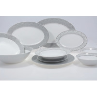 Serwis obiadowy G621 YVONNE marki Chodzież dla 12 osób. Zestaw porcelany z eleganckim szarym wzorem na białym tle, obejmujący talerze, półmiski i miski.