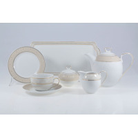 Elegancki garnitur do kawy G620 Yvonne marki Chodzież. Zestaw z białej porcelany ze złotym, ażurowym wzorem obejmuje dzbanek, cukiernicę, mlecznik, filiżankę i