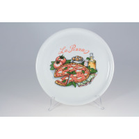 Biały talerz do pizzy Lubiana 0053 TINA o średnicy 30,5 cm. Na środku kolorowy nadruk z napisem La Pizza, grafiką pizzy, pomidorami, oliwą i przyprawami.