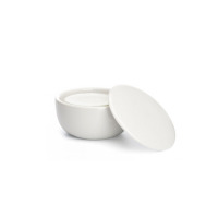 Biały porcelanowy tygiel do mydła do golenia marki Mühle z otwartą pokrywką obok, ukazujący wnętrze naczynia w minimalistycznym stylu.