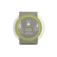 Mydło do golenia MUHLE z aloesem w porcelanowym tyglu. Okrągłe opakowanie z szaro-zieloną etykietą z logo marki, nazwą produktu i grafiką rośliny aloesu.