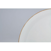 Zbliżenie na krawędź białego talerza płytkiego 24 cm BOSS marki Lubiana, wyróżniającego się subtelnym, brązowym wykończeniem obrzeża w minimalistycznym stylu.