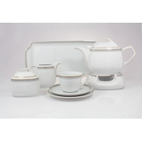 Zestaw do herbaty Ćmielów Pułaski 8051 dla 6 osób z białej porcelany. Komplet zawiera dzbanek na podgrzewaczu, cukiernicę, mlecznik, filiżankę ze spodkiem i