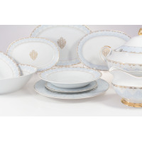 Elegancki serwis obiadowy Ćmielów G684 Astra Królewski błękit dla 6 osób. Zestaw 25 części z porcelany w kolorze bieli, zdobiony niebieskim ornamentem i złotem.