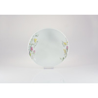 Salaterka 17 cm G763 YVETTE marki Chodzież z białej porcelany, ozdobiona delikatnym motywem polnych kwiatów po obu stronach naczynia, widok na wprost.