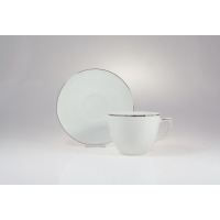 Biała porcelanowa filiżanka ze spodkiem z zestawu Chodzież B325 CITY Platynowa. Naczynia o minimalistycznym designie zdobione elegancką, srebrzystą linią na