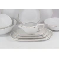 Elegancki serwis obiadowy Chodzież B326 CITY Złote dla 12 osób. Białe naczynia porcelanowe z subtelną złotą linią na krawędziach, ułożone w stosy talerze i