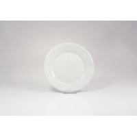 Biały talerz deserowy WERSAL marki Lubiana o średnicy 16 cm. Klasyczna, gładka porcelana o minimalistycznym designie, ustawiona na przezroczystej podstawce.