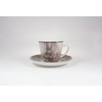Filiżanka 350 ml ze spodkiem Lubiana 9075B w kolorze brązowym. Ceramiczne naczynie ozdobione delikatnym, białym wzorem roślinnym, widoczne na wprost na jasnym