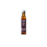 Szklana butelka z olejem do sezonowania patelni ze stali węglowej Skottsberg. Etykieta z mapą świata zawiera napis: Seasoning Oil, The original SKOTTSBERG