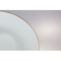 Zbliżenie na biały talerz głęboki do pasty 30 cm z serii Daisy Gold Line marki Lubiana, wyróżniający się subtelnym, żłobionym wzorem i eleganckim złotym rantem.
