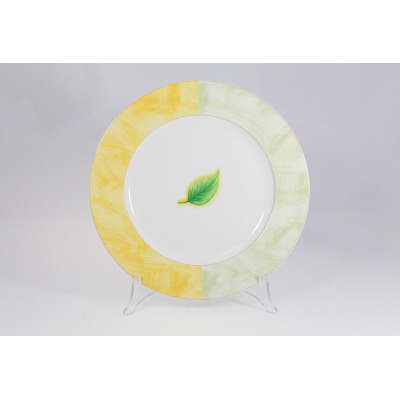 Okrągły półmisek Lubiana 0495 ROMA o średnicy 32 cm. Białe naczynie z dekoracyjnym, dwukolorowym obrzeżem w odcieniach żółci i zieleni oraz motywem zielonego