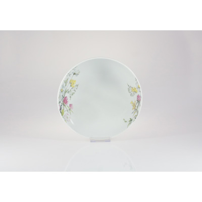 Salaterka 17 cm G763 YVETTE marki Chodzież z białej porcelany, ozdobiona delikatnym motywem polnych kwiatów po obu stronach naczynia, widok na wprost.
