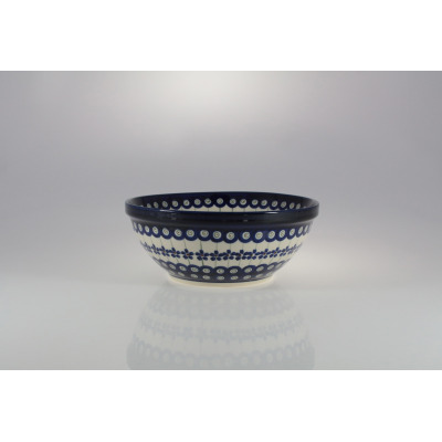 Ceramiczna miska Bolesławiec 166A o średnicy 20,7 cm. Salaterka zdobiona tradycyjnym wzorem w niebieskie kwiaty i kropki, widok z profilu na jasnym tle.