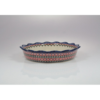 Ceramiczna miska pełna Bolesławiec 149AR o średnicy 24,8 cm z charakterystycznym falowanym brzegiem. Naczynie zdobi tradycyjny, wielobarwny wzór stempelkowy.